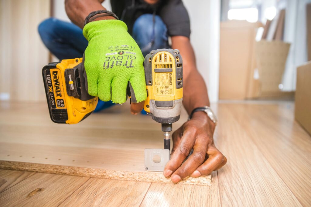 pexels-photo-1249611-1249611 Person Using Dewalt Cordless Impact Driver on Brown Board